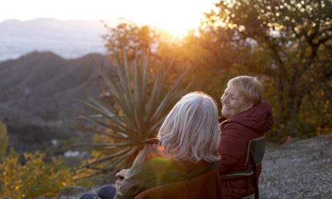 two-senior-women-nature-escapade-sitting-chairs-enjoying-their-time